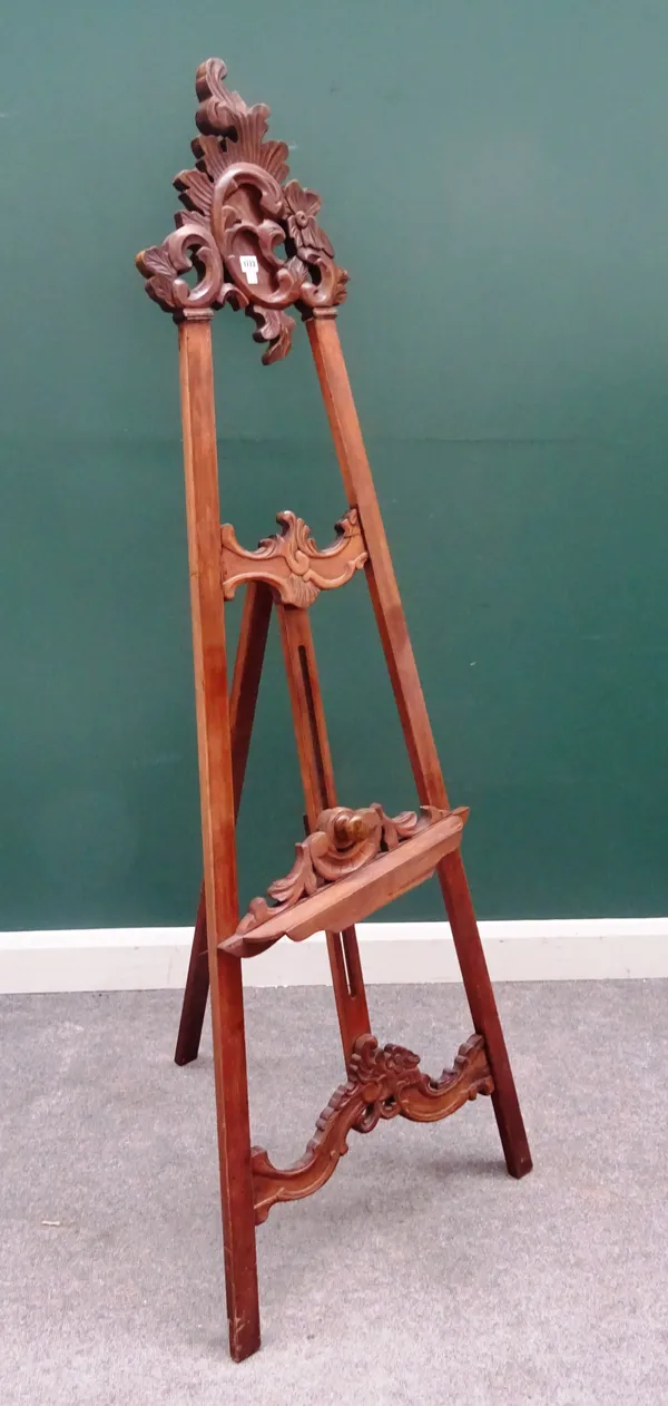 A North Italian walnut 'A' framed easel, with scroll carved crest, 67cm wide at the base.