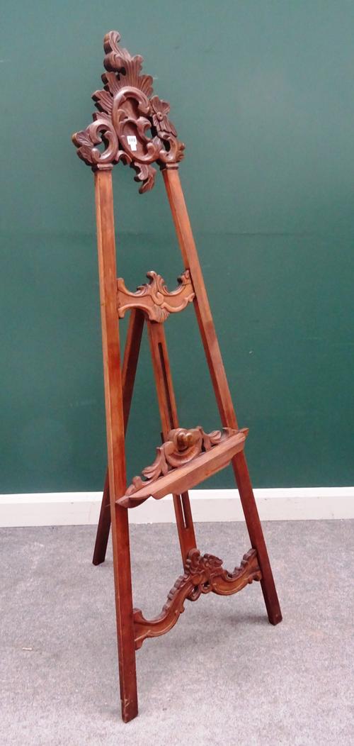 A North Italian walnut 'A' framed easel, with scroll carved crest, 67cm wide at the base.