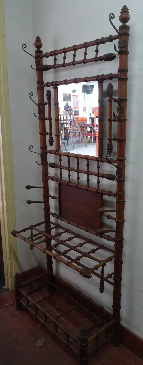 A Victorian faux bamboo turned hall stand, with mirrored back over twelve division stick stand, 86cm wide x 210cm high.