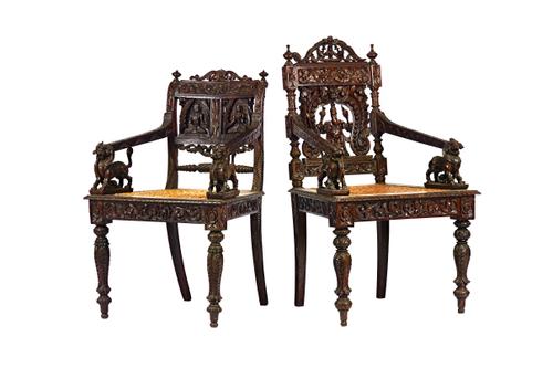 A late 19th century Burmese hardwood profusely carved open armchair, with rattan seat, 63cm wide x 104cm high, together with another similar, 59cm wid