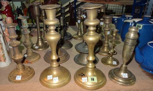 Collectables, including; a group of seventeen 18th century and later bronze and brass circular based candlesticks, (17).   S3M