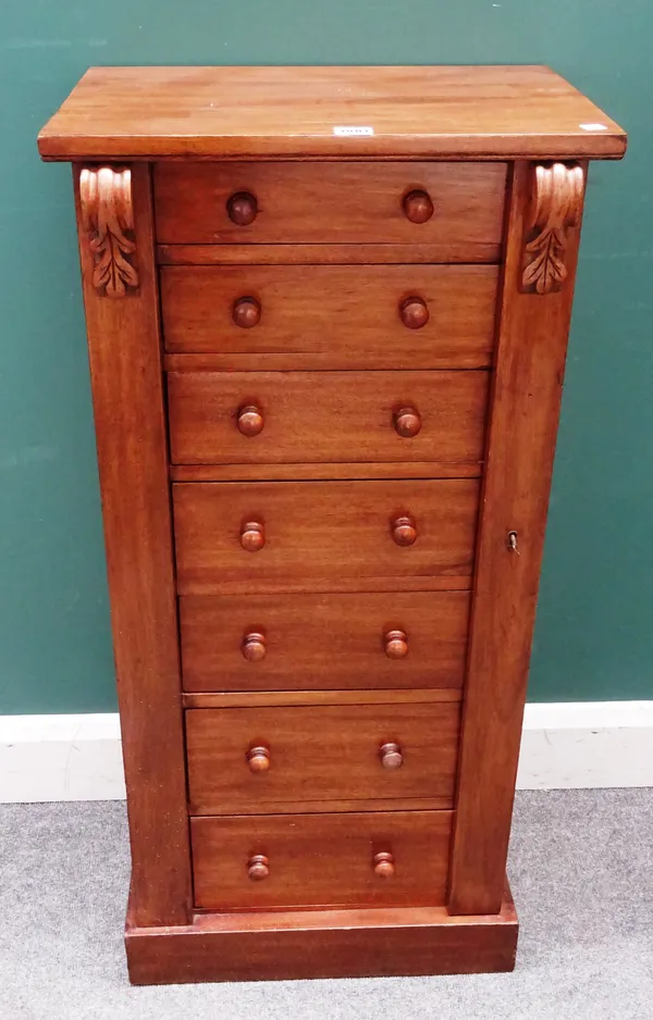 A small Victorian mahogany Wellington chest of seven graduated drawers, enclosed by locking bar, 49cm wide x 102cm high x 34cm deep.