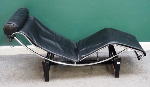 After Le Courbusier; a LC4 chaise longue with black leather upholstery, 165cm wide x 54cm high.