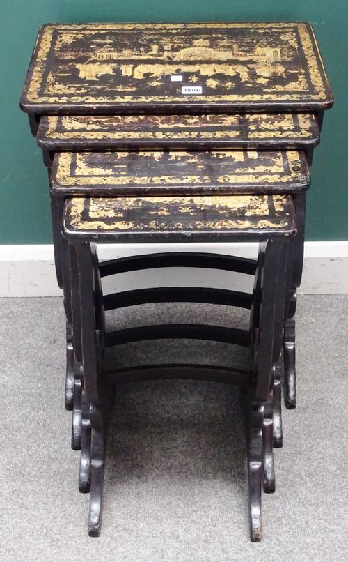 A nest of four early 19th century black lacquer chinoiserie decorated occasional tables, on pierced silhouette trestle end standards, the largest 50cm