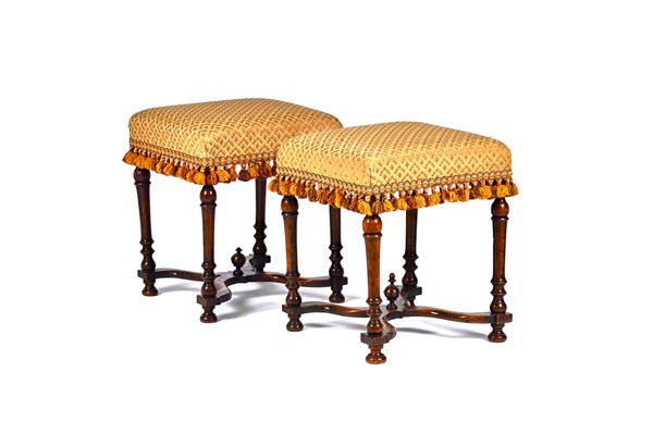 A pair of William & Mary walnut framed square footstools, each on four turned tapering supports united by shaped 'X' frame stretcher, 41cm wide x 54cm