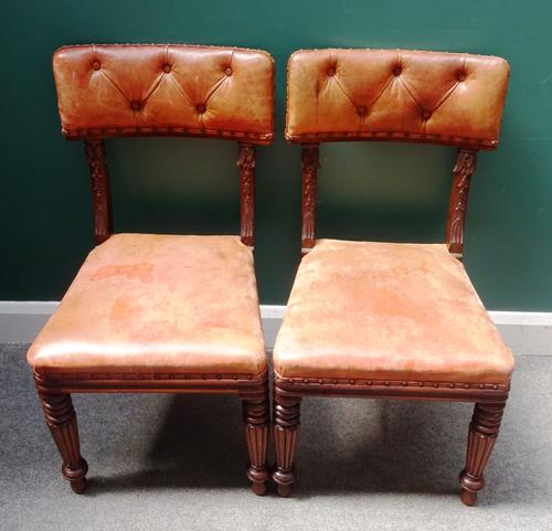 A set of six early 19th century mahogany framed dining chairs, with carved bell flower decoration, on tapering reeded supports, (6).