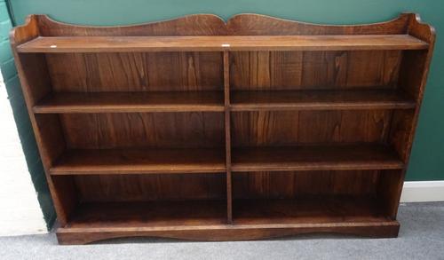 An early 20th century oak floor standing twin section open bookcase, 182cm wide x 116cm high x 26cm deep.