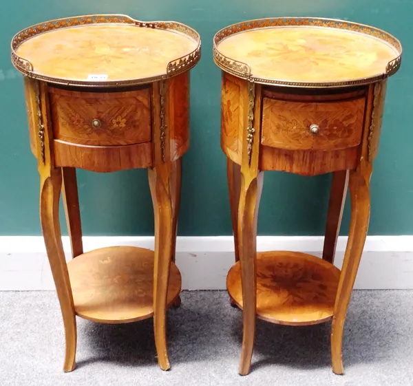 A pair of French transitional style marquetry inlaid kingwood bedside tables, each with galleried brass circular top over a single drawer base, on cab