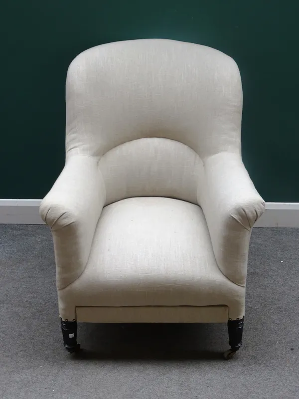 A 19th century tub back easy armchair, on reeded ebonised supports, 75cm wide x 98cm high.