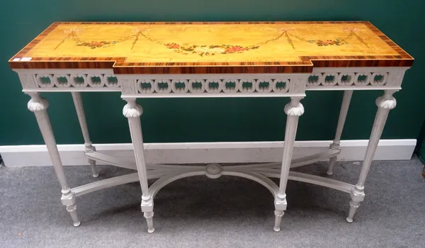 An 18th century style console, the floral painted satinwood break front top on a cream painted base, with six tapering fluted supports, 143cm wide x 8