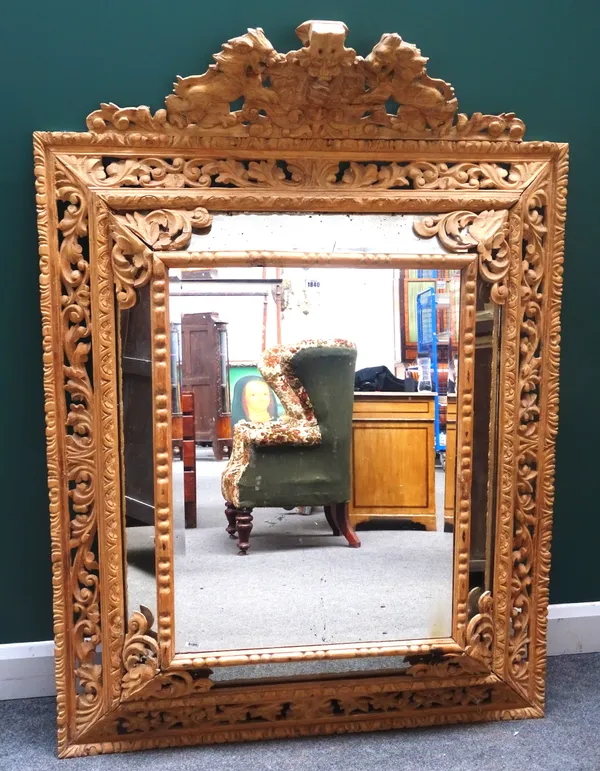 A large 19th century stripped beech cushion framed marginal mirror, with opposing lion crest, 114cm wide x 157cm high.