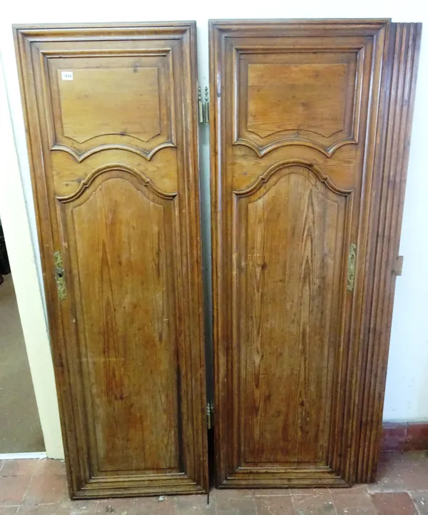 Two 19th century French pine triple arch panel armoire doors, one 66cm wide and the other 56cm wide, both 177cm high, (2).