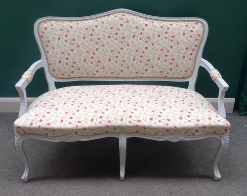 A 20th century open arm sofa, with grey painted show frame and double serpentine seat, on floral capped cabriole supports, upholstered in birds and fa