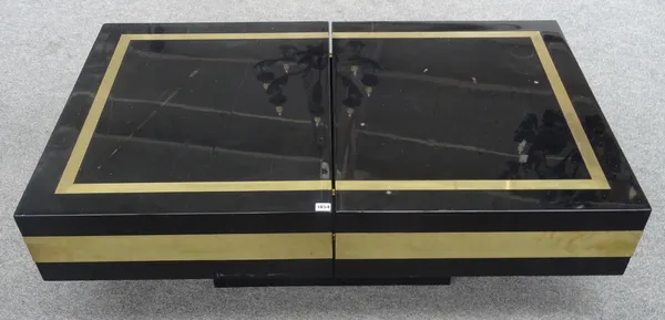 Jean Claude Mahey; a 20th century black lacquer and lacquered brass coffee table, the rectangular slide-open top revealing a recessed interior with fi
