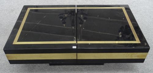 Jean Claude Mahey; a 20th century black lacquer and lacquered brass coffee table, the rectangular slide-open top revealing a recessed interior with fi