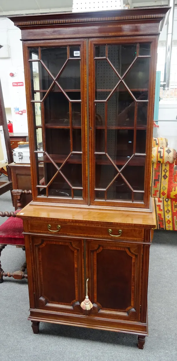 An Edwardian rosewood bounded mahogany display cabinet/cupboard, the pair of astral glazed doors over panel cupboards, 82cm wide x 190cm high x 43cm d