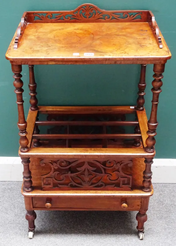 A Victorian figured walnut Canterbury whatnot, with fret carved decoration and single drawer base, 53cm wide x 90cm high x 38cm deep.