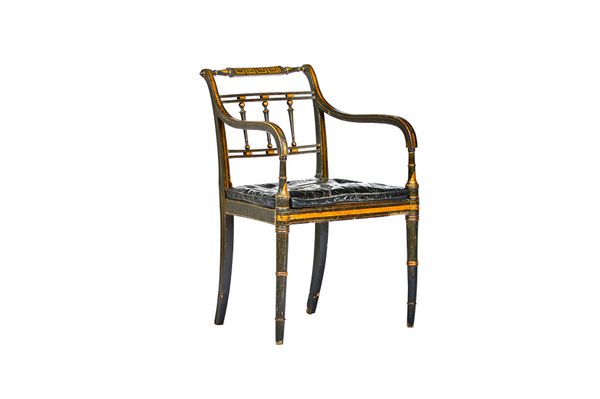 A Regency parcel gilt ebonised open armchair, on tapering turned supports, 55cm wide x 86cm high.