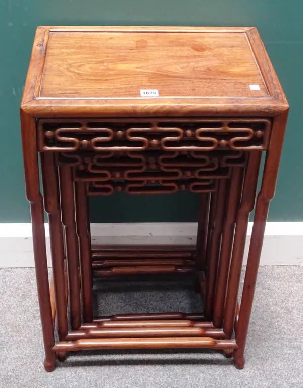 A nest of four early 20th century Chinese hardwood occasional tables, each with cloud carved frieze, on instepped turned supports united by perimeter