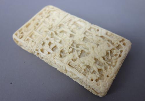 A Canton ivory rectangular card case, late 19th century, carved each side with figures and a horse amongst pavilions and trees, 9.5cm. high.
