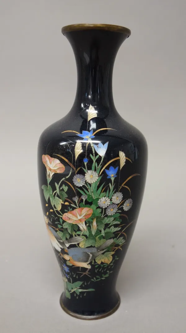 A small Japanese cloisonné vase, Meiji period, of slender ovoid form, worked with two birds amongst convolvulus and other flowers against a midnight b