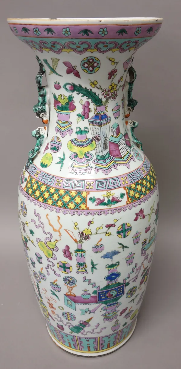 A Chinese famille-rose two-handled baluster vase, 20th century, painted with Buddhist emblems, the waisted neck with lion and cub handles, 58cm. high.
