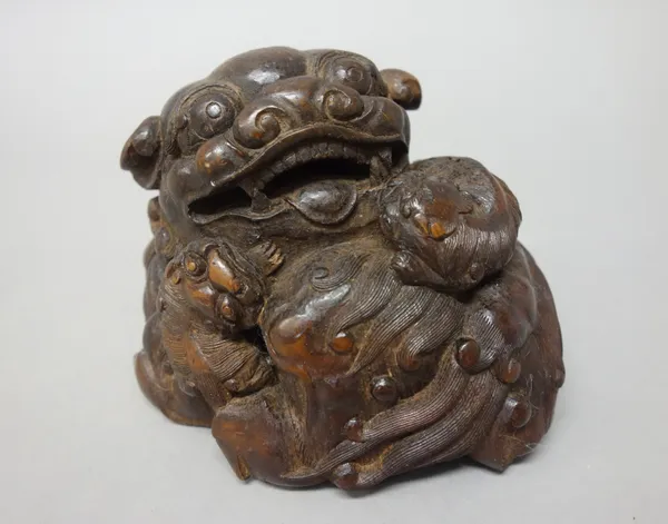 A Chinese bamboo group of a lion dog with two cubs, 10cm. high.