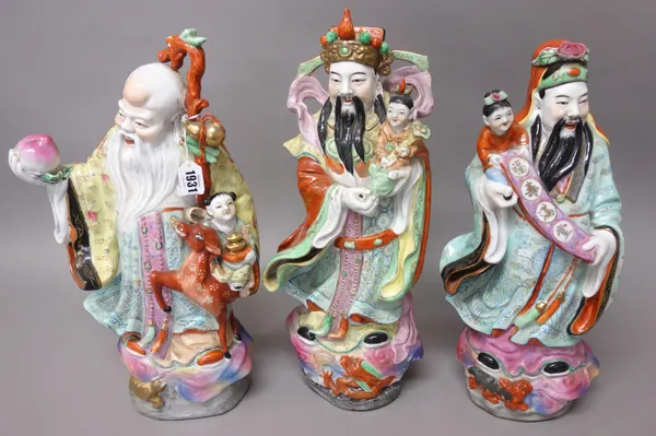 A set of three Chinese porcelain Star Gods, modern, each colourfully dressed character standing with attributes, each approx. 43cm. high, (3).