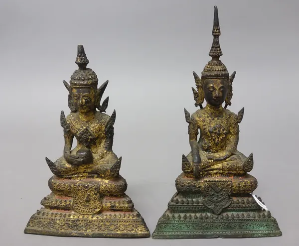 Two Thai gilt-bronze figures of Buddha, probably 19th century, each seated with serene expression on a three-tier dais, 14.5cm. and 17cm. high (2).
