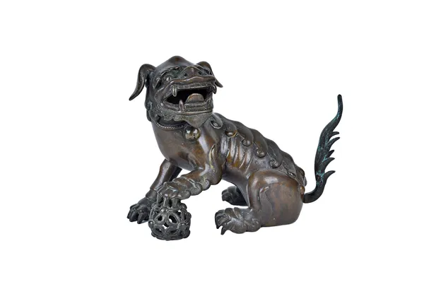A Chinese bronze model of a Buddhist lion, 18th/19th century, cast with head turned, its left paw resting on a brocade ball, 17.8cm. high.Provenance: