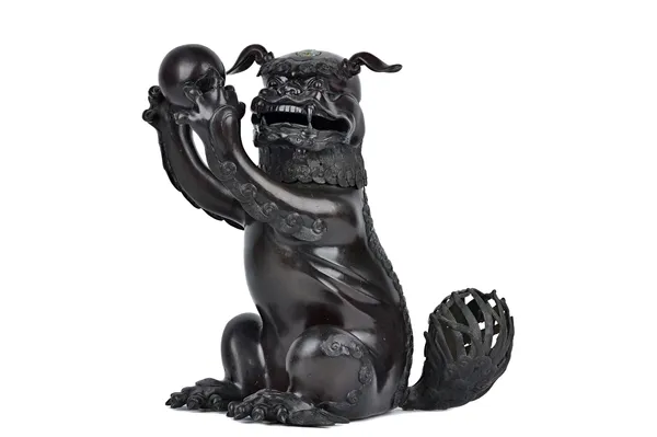 A large Chinese bronze lion censer and cover, probably 18th century, modelled seated, the front paws outstretched clasping a spherical ball, the detac