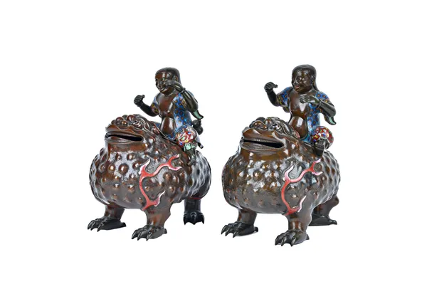 A pair of Chinese cloisonné enamel and bronze incense burners and covers, late 19th century, cast as the Immortal Liuhai seated on the back of a three