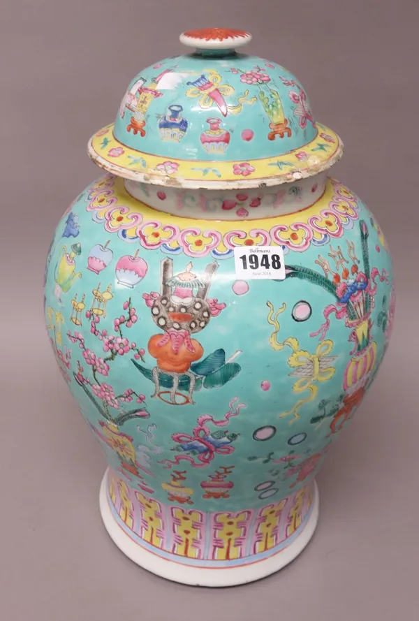 A Chinese famille-rose baluster vase and cover, circa 1900, painted with Buddhist emblems beneath a ruyi-head border against a turquoise ground, 45cm.