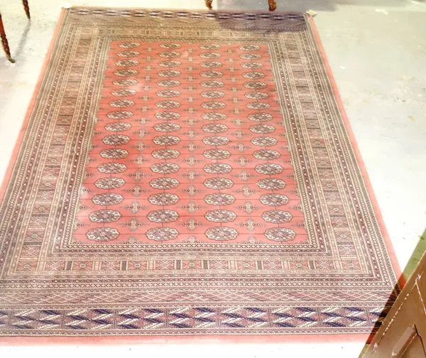 A machine made pink 'Bokhara' carpet, 240cm x 173cm.  H4
