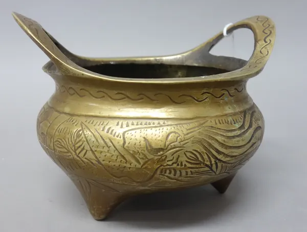 A Chinese brass censer, 20th century, the squat body incised with a dragon and pheasant, six character Xuande mark to base, 16.5cm. across handles.