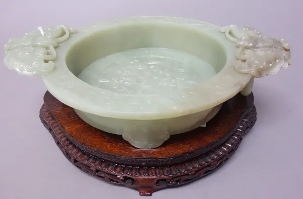 A Chinese green hardstone marriage bowl, 20th century, set with butterfly and ring handles, the interior with two chilong around a flaming pearl, rais