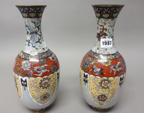A pair of Japanese cloisonné vases, Meiji period, worked with lappet panels enclosing flowers alternating with ho-ho birds, the necks with further bir