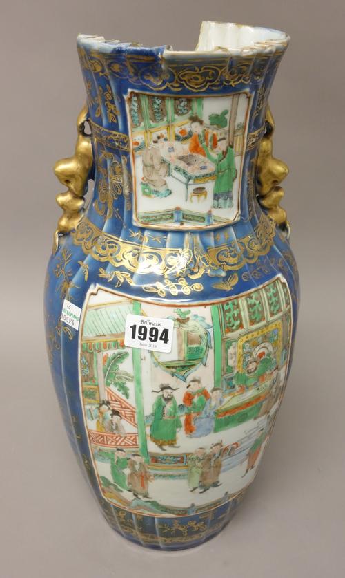 A Chinese famille-verte two-handled baluster vase, 19th century, each side painted with figurative panels against a blue ground gilt with flowers and