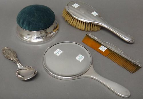 Silver mounted wares, comprising; a hand mirror, with engine turned decoration, London 1947, a hairbrush and a comb, both Chester 1922 and a circular