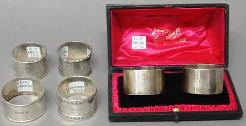 Silver, comprising; a pair of napkin rings, monogram engraved, London 1899, with a case, a pair of Victorian napkin rings, with floral and foliate eng