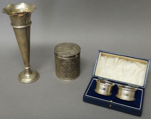 A Chinese trumpet shaped vase, decorated with a wavy rim, raised on a circular base, detailed Shanghai Wingon, height 21cm, a pair of silver napkin ri