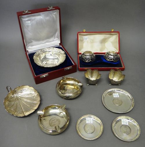 Mostly Indian wares, comprising; one larger and two smaller circular dishes inset with Indian coins, two circular ashtrays inset with Indian coins, a