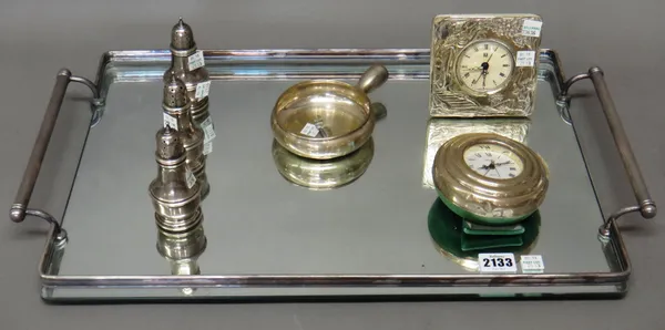 Three Sterling pepperettes, combined weight 159 gms, a circular bowl, detailed 800, a silver mounted quartz clock, detailed 925, a circular quartz clo