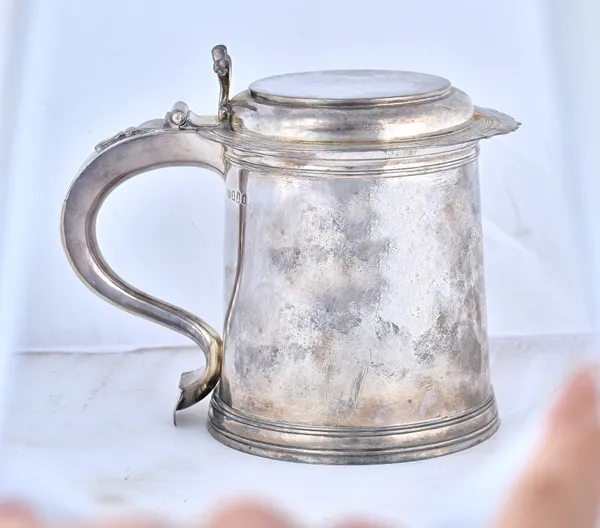 A Britannia Standard silver hinge lidded tankard, of tapering cylindrical form, with a cast thumbpiece, in the 17th century taste, height 18.5cm, the