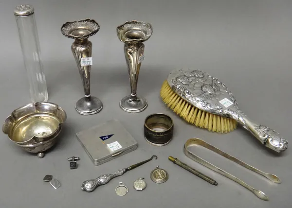 Mostly silver and silver mounted wares, comprising; a square powder compact, the front with an enamelled flag, numbered 130, a pair of sugar tongs, pr