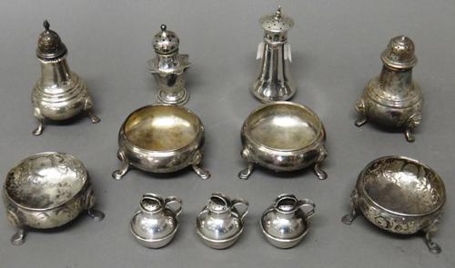 Silver condiments, comprising; a pair of George II salts, each of circular cauldron form, raised on three feet, London 1754, two similar salts, with l