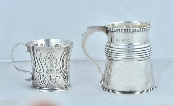 A George IIi silver christening mug of tapered form, the rim with egg and dart decoration, the footrim reeded and decorated to the body with a fluted