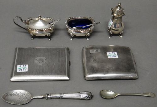 A silver three piece cruet set, comprising; a mustard pot, a salt and a pepperette, Birmingham 1974, with two blue glass liners, a silver jam spoon, h