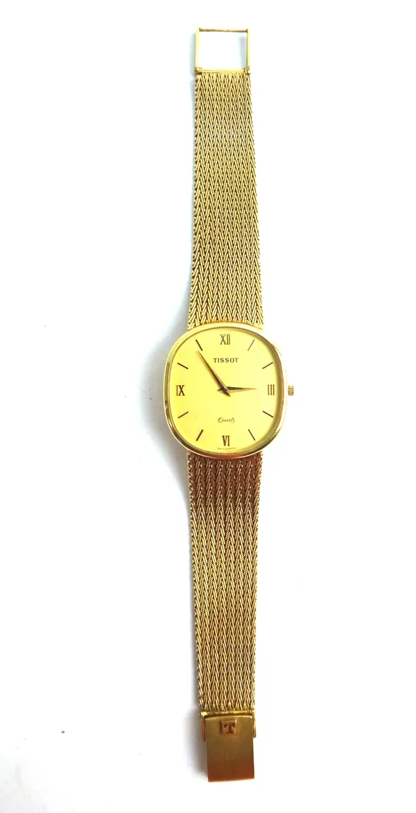 A Tissot Quartz 9ct gold gentleman's bracelet wristwatch, the signed oval gilt dial, with Roman and baton numerals and with tapering gilt hands, on a