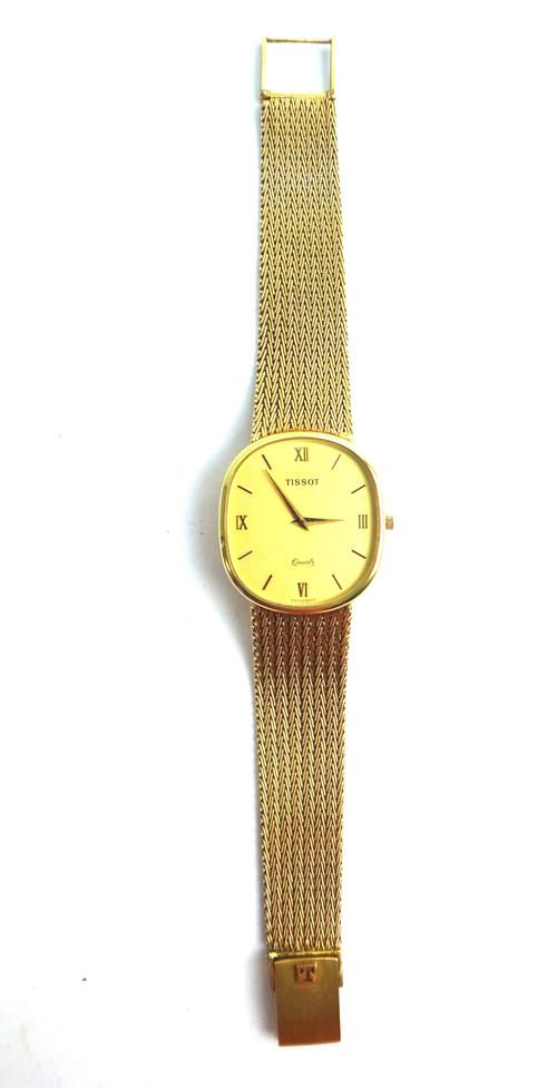 A Tissot Quartz 9ct gold gentleman's bracelet wristwatch, the signed oval gilt dial, with Roman and baton numerals and with tapering gilt hands, on a